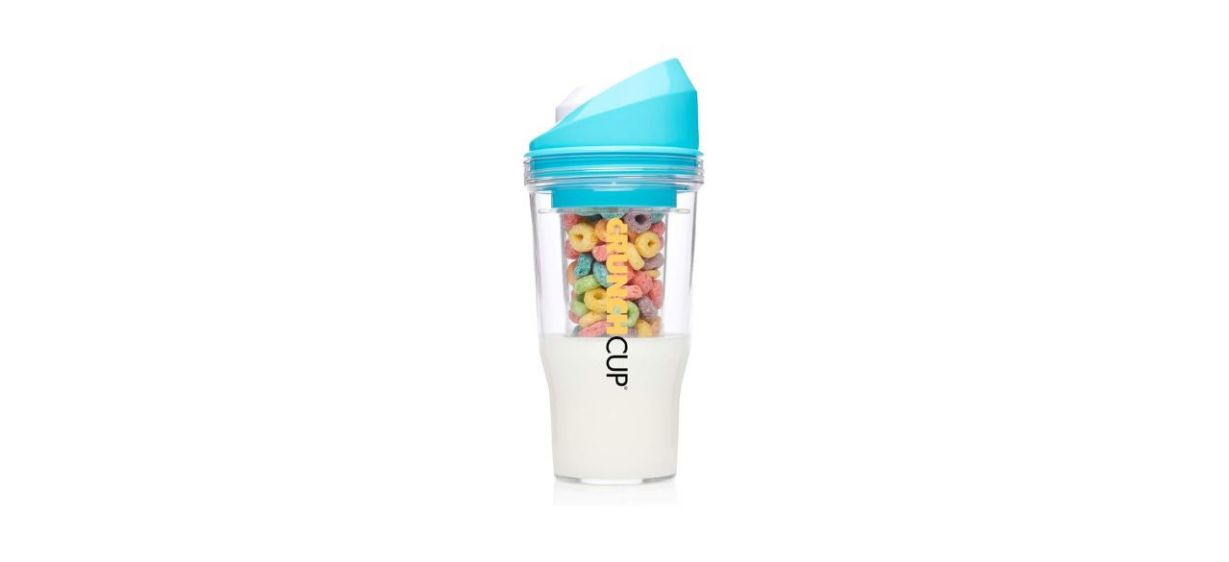 a cup with milk and cereal in it a cup with milk and cereal in it