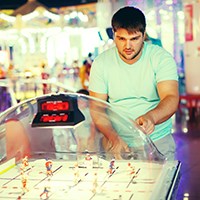 Person playing on dome air hockey table