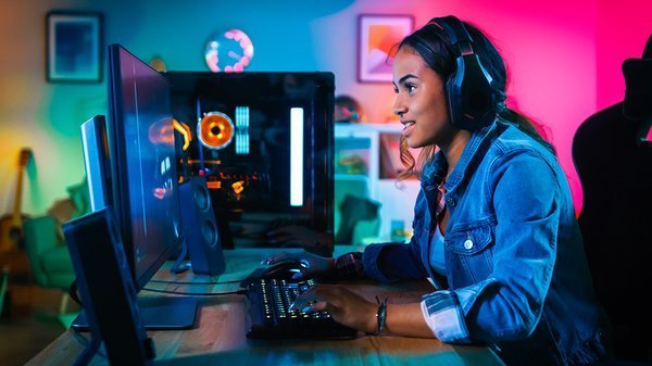 Woman playing a video game at a desk
