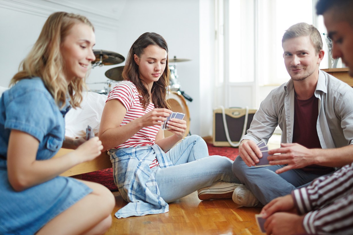 a group of friends playing cards